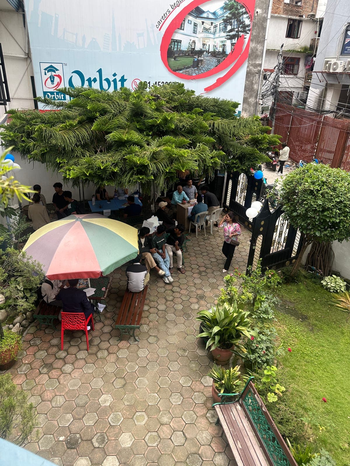 Students meeting Orbit counsellors in the courtyard of Orbit's Dillibazar office